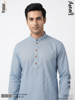 Man wearing a blue patterned kurta with brown buttons on a light gray background