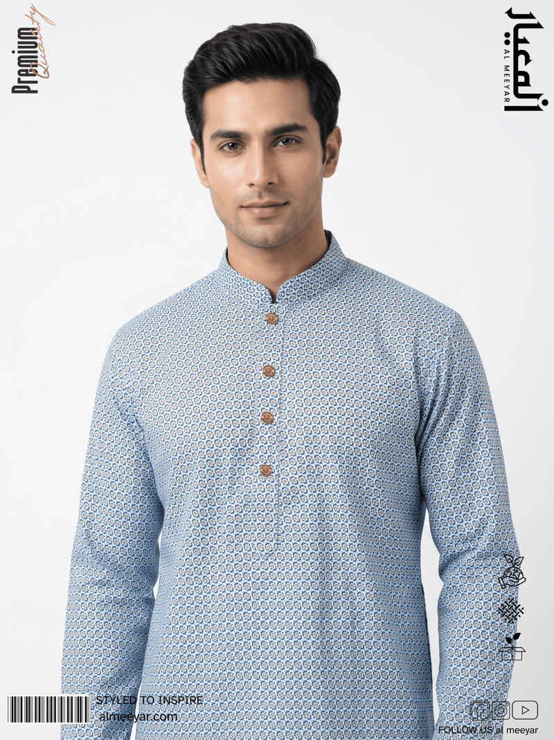 Man wearing a blue patterned kurta with brown buttons on a light gray background